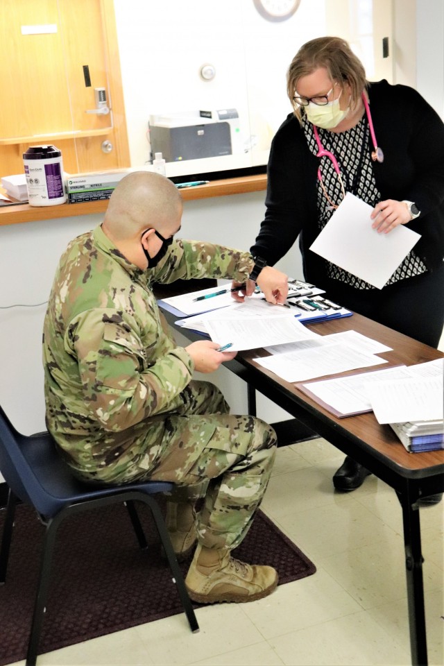 Post personnel receive paperwork to complete in order to receive a COVID-19 vaccination Jan. 26, 2021, at the Fort McCoy Health Clinic during the first round of COVID-19 vaccinations at Fort McCoy, Wis. Several people received the vaccine at the post Jan. 26. The effort was the beginning of many rounds of vaccinations at the installation. The COVID-19 vaccine is now available due in large part to the Department of Defense effort for Operation Warp Speed to get vaccines to the American people. (U.S. Army Photo by Scott T. Sturkol, Public Affairs Office, Fort McCoy, Wis.)
