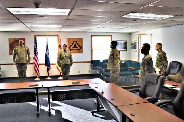 Fort McCoy Garrison Commander Col. Michael D. Poss prepares to present Master Sgt. Cynthia P. Johnson with an Army Meritorious Service Medal on Jan. 22, 2021, at the garrison headquarters building at Fort McCoy, Wis. Johnson earned the medal for meritorious service with Fort McCoy Garrison between 2018 and 2021. (U.S. Army Photo by Scott T. Sturkol, Public Affairs Office, Fort McCoy, Wis.)