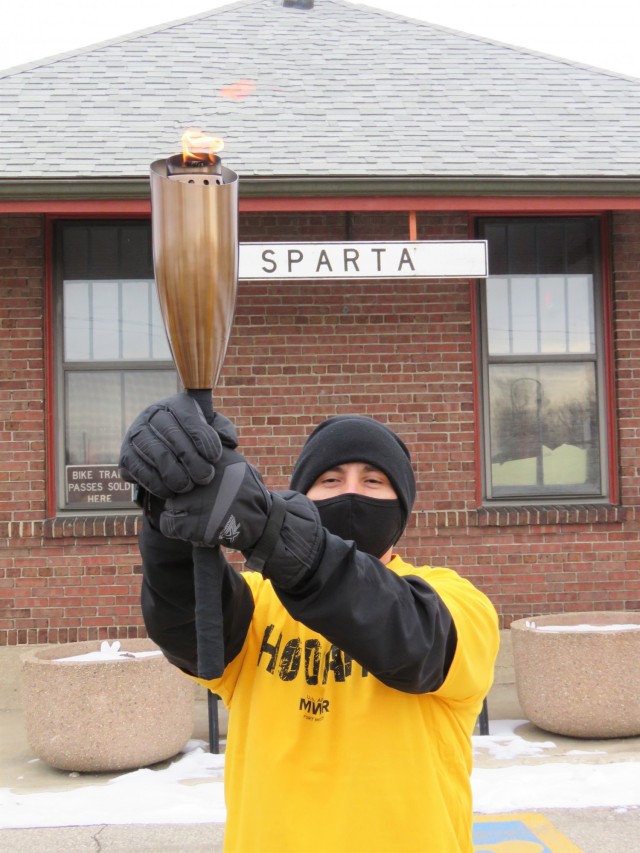 Members of the Fort McCoy, Wis., Army Ten-Miler team carry an event torch Jan. 29, 2021, as part of the opening ceremony of the Sparta Quest Winter Fest in Sparta, Wis. On Jan. 29, members of the team, along with Command Sgt. Maj. Paul Mantha,...