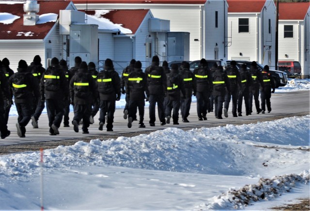 U.S. Navy recruits walk on the cantonment area Jan. 28, 2021, at Fort McCoy, Wis. The Navy’s Recruit Training Command (RTC) of Great Lakes, Ill., worked with the Army in 2020 at Fort McCoy so the post could serve as a restriction-of-movement (ROM) site for Navy recruits prior to entering basic training. Additional personnel support from the Navy’s Great Lakes, Ill., Millington, Tenn., and Washington, D.C., sites deployed to McCoy to assist RTC in conducting the initial 14-day ROM to help reduce the risk of bringing the coronavirus to RTC should any individual be infected. More than 40,000 recruits train annually at the Navy’s only boot camp. This is also the first time Fort McCoy has supported the Navy in this capacity. Fort McCoy’s motto is to be the “Total Force Training Center.” (U.S. Army Photo by Scott T. Sturkol, Public Affairs Office, Fort McCoy, Wis.)