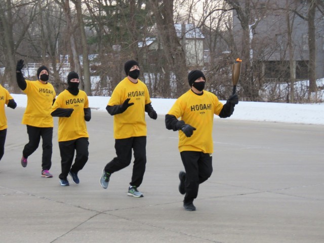 Members of the Fort McCoy, Wis., Army Ten-Miler team carry an event torch Jan. 29, 2021, as part of the opening ceremony of the Sparta Quest Winter Fest in Sparta, Wis. On Jan. 29, members of the team, along with Command Sgt. Maj. Paul Mantha,...