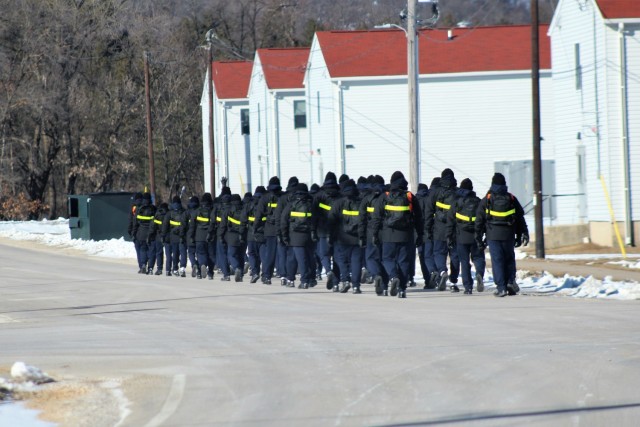 U.S. Navy recruits walk on the cantonment area Jan. 22, 2021, at Fort McCoy, Wis. The Navy’s Recruit Training Command (RTC) of Great Lakes, Ill., worked with the Army in 2020 at Fort McCoy so the post could serve as a restriction-of-movement (ROM) site for Navy recruits prior to entering basic training. Additional personnel support from the Navy’s Great Lakes, Ill., Millington, Tenn., and Washington, D.C., sites deployed to McCoy to assist RTC in conducting the initial 14-day ROM to help reduce the risk of bringing the coronavirus to RTC should any individual be infected. More than 40,000 recruits train annually at the Navy’s only boot camp. This is also the first time Fort McCoy has supported the Navy in this capacity. Fort McCoy’s motto is to be the “Total Force Training Center.” (U.S. Army Photo by Scott T. Sturkol, Public Affairs Office, Fort McCoy, Wis.)