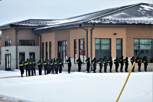 U.S. Navy recruits walk to a dining facility Jan. 28, 2021, at Fort McCoy, Wis. The Navy’s Recruit Training Command (RTC) of Great Lakes, Ill., worked with the Army in 2020 at Fort McCoy so the post could serve as a restriction-of-movement (ROM) site for Navy recruits prior to entering basic training. Additional personnel support from the Navy’s Great Lakes, Ill., Millington, Tenn., and Washington, D.C., sites deployed to McCoy to assist RTC in conducting the initial 14-day ROM to help reduce the risk of bringing the coronavirus to RTC should any individual be infected. More than 40,000 recruits train annually at the Navy’s only boot camp. This is also the first time Fort McCoy has supported the Navy in this capacity. Fort McCoy’s motto is to be the “Total Force Training Center.” (U.S. Army Photo by Scott T. Sturkol, Public Affairs Office, Fort McCoy, Wis.)