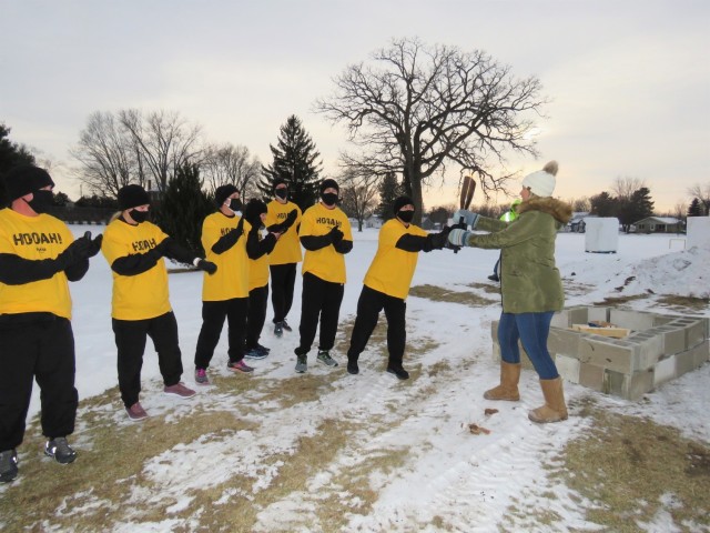 Members of the Fort McCoy, Wis., Army Ten-Miler team hand over an event torch Jan. 29, 2021, as part of the opening ceremony of the Sparta Quest Winter Fest in Sparta, Wis. On Jan. 29, members of the team, along with Command Sgt. Maj. Paul Mantha,...