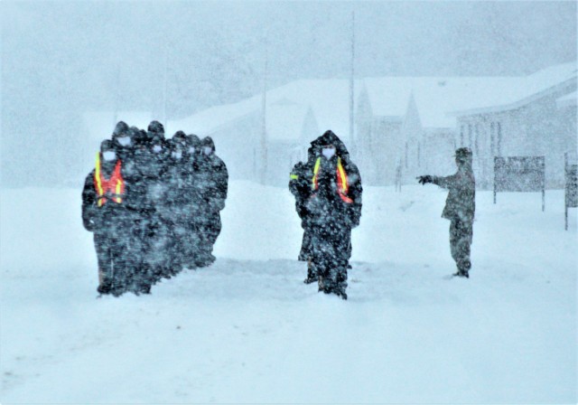 U.S. Navy recruits walk on the cantonment area in a snowstorm Feb. 4, 2021, at Fort McCoy, Wis. The Navy’s Recruit Training Command (RTC) of Great Lakes, Ill., worked with the Army in 2020 at Fort McCoy so the post could serve as a restriction-of-movement (ROM) site for Navy recruits prior to entering basic training. Additional personnel support from the Navy’s Great Lakes, Ill., Millington, Tenn., and Washington, D.C., sites deployed to McCoy to assist RTC in conducting the initial 14-day ROM to help reduce the risk of bringing the coronavirus to RTC should any individual be infected. More than 40,000 recruits train annually at the Navy’s only boot camp. This is also the first time Fort McCoy has supported the Navy in this capacity. Fort McCoy’s motto is to be the “Total Force Training Center.” (U.S. Army Photo by Scott T. Sturkol, Public Affairs Office, Fort McCoy, Wis.)