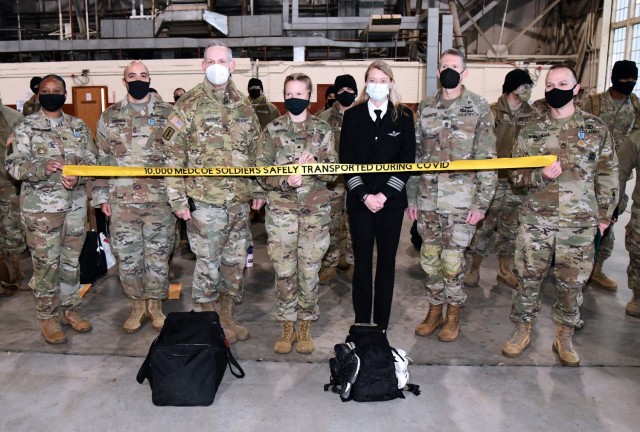 SFC Francisco Bautista, Maj. Gen. Dennis LeMaster, Spc Angela thresher, Captain Crystal Vaughan , Command Sgt. Maj. Clark Charpentier, and SFC Steven Wiechert.

U.S. Army Medical Center of Excellence on February 11, 2021 as they conducted a controlled outbound movement from Joint Base San Antonio (JBSA)- Kelly Field for over 250 Soldiers departing Advanced Individual Training (AIT) in various medical military occupational specialties at JBSA on February 11, 2021.

With this move, the medical education and training institution commemorated the 10,000th AIT Soldier moved in this controlled manner as part of their COVID-19 mitigation measures. All outbound Soldiers who depart the relative safety bubble of the training environment are confirmed COVID-negative. The first controlled movement was nine months ago on April 7, 2020.
