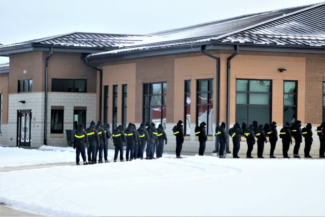 U.S. Navy recruits walk to a dining facility Jan. 28, 2021, at Fort McCoy, Wis. The Navy’s Recruit Training Command (RTC) of Great Lakes, Ill., worked with the Army in 2020 at Fort McCoy so the post could serve as a restriction-of-movement (ROM) site for Navy recruits prior to entering basic training. Additional personnel support from the Navy’s Great Lakes, Ill., Millington, Tenn., and Washington, D.C., sites deployed to McCoy to assist RTC in conducting the initial 14-day ROM to help reduce the risk of bringing the coronavirus to RTC should any individual be infected. More than 40,000 recruits train annually at the Navy’s only boot camp. This is also the first time Fort McCoy has supported the Navy in this capacity. Fort McCoy’s motto is to be the “Total Force Training Center.” (U.S. Army Photo by Scott T. Sturkol, Public Affairs Office, Fort McCoy, Wis.)