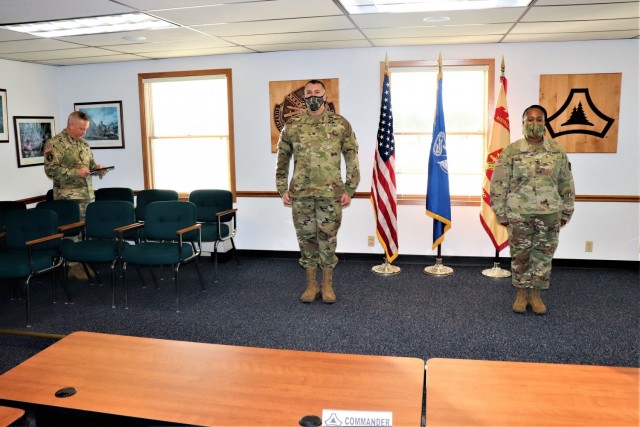 Fort McCoy Garrison Commander Col. Michael D. Poss prepares to present Master Sgt. Cynthia P. Johnson with an Army Meritorious Service Medal on Jan. 22, 2021, at the garrison headquarters building at Fort McCoy, Wis. Johnson earned the medal for meritorious service with Fort McCoy Garrison between 2018 and 2021. (U.S. Army Photo by Scott T. Sturkol, Public Affairs Office, Fort McCoy, Wis.)