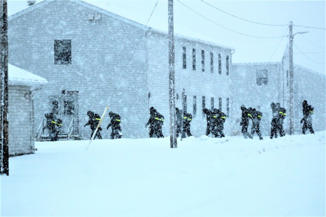 U.S. Navy recruits walk on the cantonment area in a snowstorm Feb. 4, 2021, at Fort McCoy, Wis. The Navy’s Recruit Training Command (RTC) of Great Lakes, Ill., worked with the Army in 2020 at Fort McCoy so the post could serve as a restriction-of-movement (ROM) site for Navy recruits prior to entering basic training. Additional personnel support from the Navy’s Great Lakes, Ill., Millington, Tenn., and Washington, D.C., sites deployed to McCoy to assist RTC in conducting the initial 14-day ROM to help reduce the risk of bringing the coronavirus to RTC should any individual be infected. More than 40,000 recruits train annually at the Navy’s only boot camp. This is also the first time Fort McCoy has supported the Navy in this capacity. Fort McCoy’s motto is to be the “Total Force Training Center.” (U.S. Army Photo by Scott T. Sturkol, Public Affairs Office, Fort McCoy, Wis.)