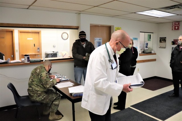 Post personnel receive paperwork to complete in order to receive a COVID-19 vaccination Jan. 26, 2021, at the Fort McCoy Health Clinic during the first round of COVID-19 vaccinations at Fort McCoy, Wis. Several people received the vaccine at the...