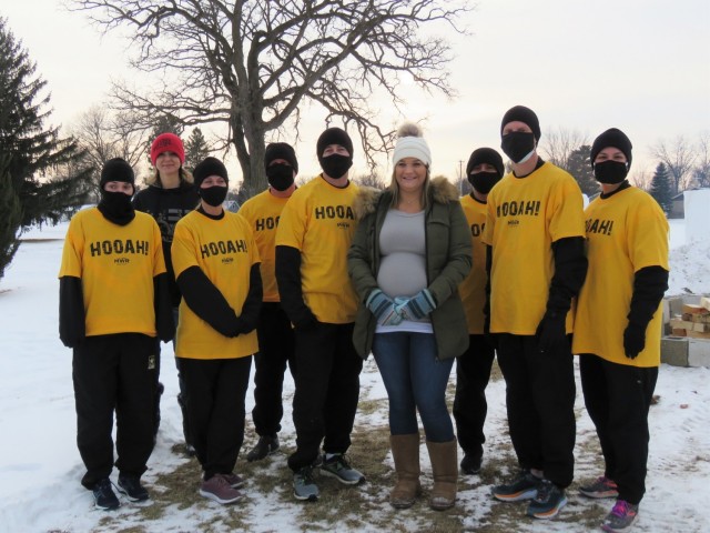 Members of the Fort McCoy, Wis., Army Ten-Miler team prepare to carry an event torch Jan. 29, 2021, as part of the opening ceremony of the Sparta Quest Winter Fest in Sparta, Wis. On Jan. 29, members of the team, along with Command Sgt. Maj. Paul...