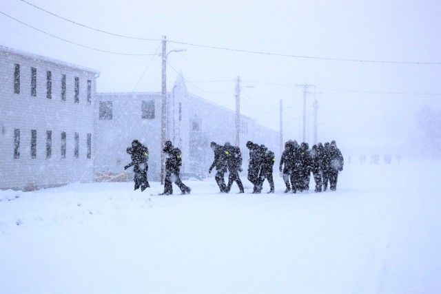 U.S. Navy recruits walk on the cantonment area in a snowstorm Feb. 4, 2021, at Fort McCoy, Wis. The Navy’s Recruit Training Command (RTC) of Great Lakes, Ill., worked with the Army in 2020 at Fort McCoy so the post could serve as a restriction-of-movement (ROM) site for Navy recruits prior to entering basic training. Additional personnel support from the Navy’s Great Lakes, Ill., Millington, Tenn., and Washington, D.C., sites deployed to McCoy to assist RTC in conducting the initial 14-day ROM to help reduce the risk of bringing the coronavirus to RTC should any individual be infected. More than 40,000 recruits train annually at the Navy’s only boot camp. This is also the first time Fort McCoy has supported the Navy in this capacity. Fort McCoy’s motto is to be the “Total Force Training Center.” (U.S. Army Photo by Scott T. Sturkol, Public Affairs Office, Fort McCoy, Wis.)