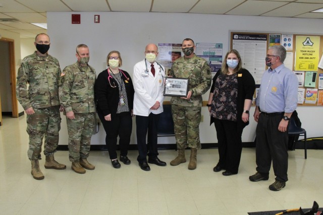 Members of the Fort McCoy Garrison command team are shown with staff members of the Fort McCoy Health Clinic on Jan. 26, 2021, to present the clinic staff with a certificate of appreciation to thank them for preparing the installation for the...