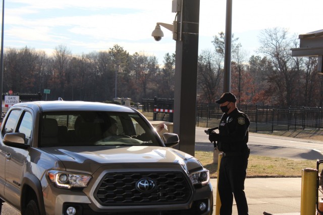 A police officer with the Directorate of Emergency Services Police Department scans an identification card while practicing COVID-19 safety protocols Dec. 3, 2020, at Fort McCoy, Wis. Throughout the installation's pandemic response, which started in March 2020, the police officers of Fort McCoy have remained on duty 24 hours a day, seven days a week. (U.S. Army Photo by Scott T. Sturkol, Public Affairs Office, Fort McCoy, Wis.)