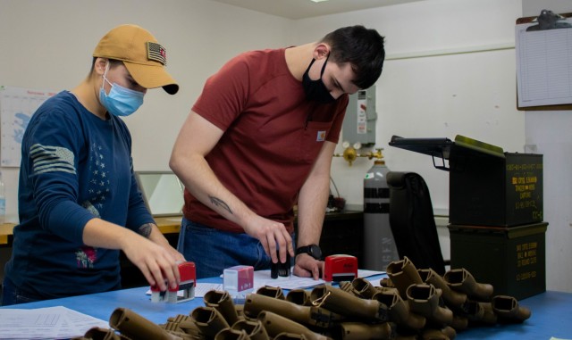 U.S. Army Pfc. Jennifer Vaughn-Glashoff and Sgt. Joseph Chiddix, armorers with the 317th Support Maintenance Company, 18th Combat Sustainment Support Brigade, 16th Sustainment Brigade, out of Baumholder, Germany, confirm inventory during an annual weapons inspection at Camp Bondsteel, Kosovo, on Feb. 9, 2021. Camp Bondsteel performs weapons inspections annually to ensure all firearms and accessories are functional and will perform correctly. (U.S. Army National Guard photo by Sgt. Jonathan Perdelwitz)