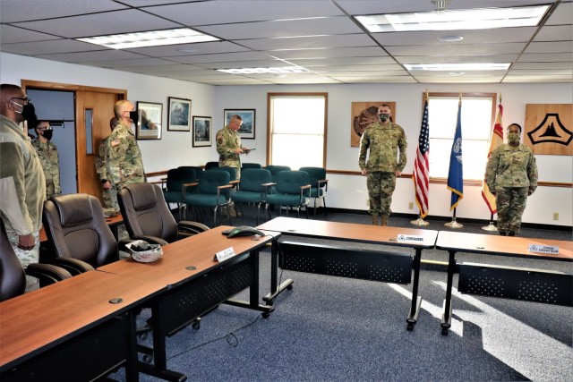 Fort McCoy Garrison Commander Col. Michael D. Poss prepares to present Master Sgt. Cynthia P. Johnson with an Army Meritorious Service Medal on Jan. 22, 2021, at the garrison headquarters building at Fort McCoy, Wis. Johnson earned the medal for meritorious service with Fort McCoy Garrison between 2018 and 2021. (U.S. Army Photo by Scott T. Sturkol, Public Affairs Office, Fort McCoy, Wis.)