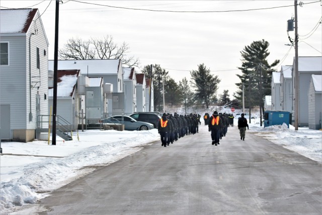 U.S. Navy recruits walk on the cantonment area Jan. 28, 2021, at Fort McCoy, Wis. The Navy’s Recruit Training Command (RTC) of Great Lakes, Ill., worked with the Army at Fort McCoy so the post could serve as a restriction-of-movement (ROM) site for Navy recruits prior to entering basic training. Additional personnel support from the Navy’s Great Lakes, Ill., Millington, Tenn., and Washington, D.C., sites deployed to McCoy to assist RTC in conducting the initial 14-day ROM to help reduce the risk of bringing the coronavirus to RTC should any individual be infected. More than 40,000 recruits train annually at the Navy’s only boot camp. This is also the first time Fort McCoy has supported the Navy in this capacity. Fort McCoy’s motto is to be the “Total Force Training Center.” (U.S. Army Photo by Scott T. Sturkol, Public Affairs Office, Fort McCoy, Wis.)