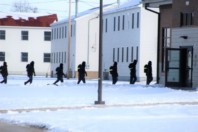 U.S. Navy recruits walk on the cantonment area Jan. 28, 2021, at Fort McCoy, Wis. The Navy’s Recruit Training Command (RTC) of Great Lakes, Ill., worked with the Army in 2020 at Fort McCoy so the post could serve as a restriction-of-movement (ROM) site for Navy recruits prior to entering basic training. Additional personnel support from the Navy’s Great Lakes, Ill., Millington, Tenn., and Washington, D.C., sites deployed to McCoy to assist RTC in conducting the initial 14-day ROM to help reduce the risk of bringing the coronavirus to RTC should any individual be infected. More than 40,000 recruits train annually at the Navy’s only boot camp. This is also the first time Fort McCoy has supported the Navy in this capacity. Fort McCoy’s motto is to be the “Total Force Training Center.” (U.S. Army Photo by Scott T. Sturkol, Public Affairs Office, Fort McCoy, Wis.)