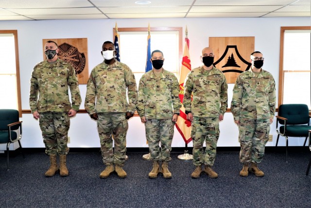 (From left) Garrison Commander Col. Michael D. Poss and Maj. Eddie Woody, 1st Sgt. Leonardo Ramos, Sgt. 1st Class Gregory Parks, and Staff Sgt. Anthony Cintron with U.S. Army Garrison-Fort McCoy's Headquarters and Headquarters Company are lined up...