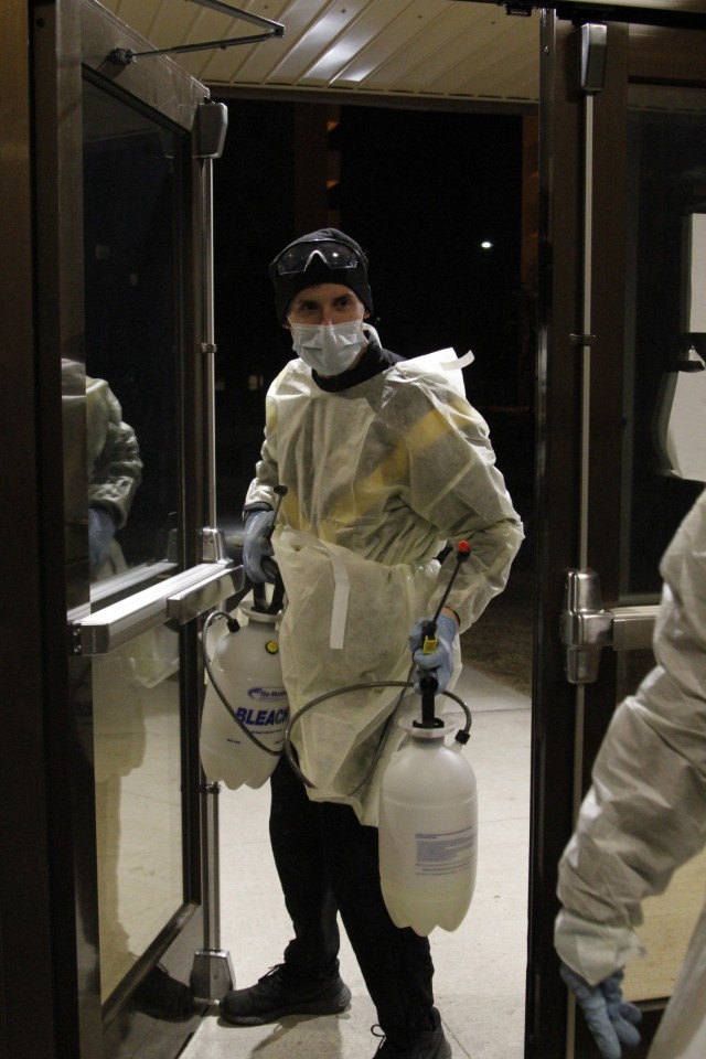 Spc. Michael Adelsperger, a Chemical, Biological, Radiological and Nuclear (CBRN) specialist with the 61st CBRN Company, enters the quarantine barracks to disinfect rooms that have been contaminated by someone who tested positive for COVID-19 on...