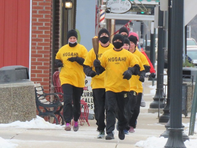 Members of the Fort McCoy, Wis., Army Ten-Miler team carry an event torch Jan. 29, 2021, as part of the opening ceremony of the Sparta Quest Winter Fest in Sparta, Wis. On Jan. 29, members of the team, along with Command Sgt. Maj. Paul Mantha,...