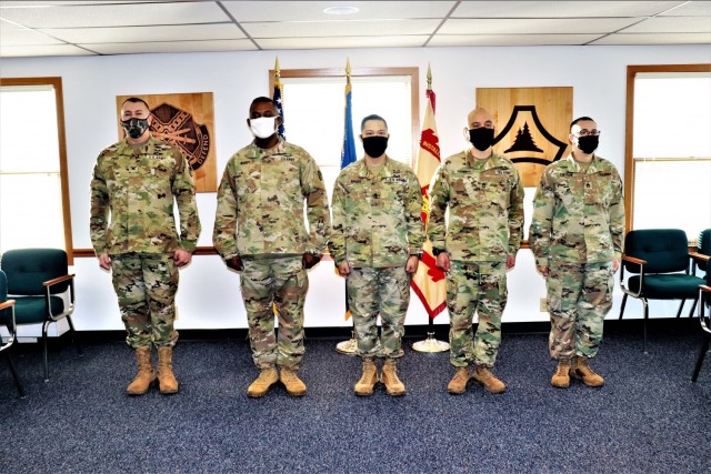 (From left) Garrison Commander Col. Michael D. Poss and Maj. Eddie Woody, 1st Sgt. Leonardo Ramos, Sgt. 1st Class Gregory Parks, and Staff Sgt. Anthony Cintron with U.S. Army Garrison-Fort McCoy's Headquarters and Headquarters Company are lined up...