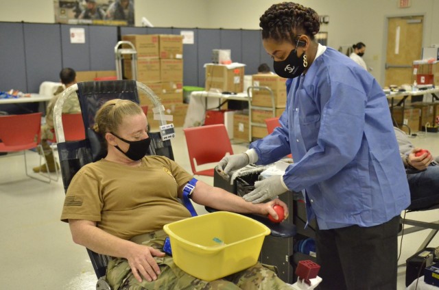 Chiquita Waters, phlebotomist with the Armed Services Blood Program, prepares to draw blood from Sgt. Mickey Cawley, 41st Medical Detachment, 531st Hospital Center, Feb. 5 during a blood drive at the Soldier Support Center.