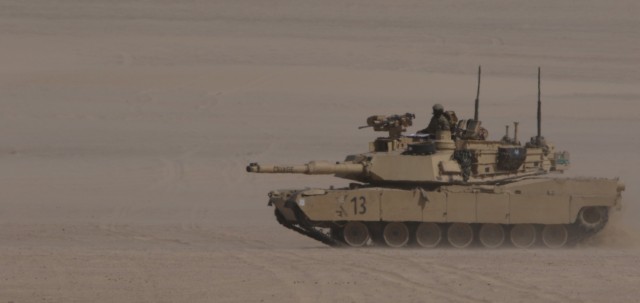 U.S. Army Soldiers, 1st Battalion, 6th Infantry Regiment, 2nd Brigade Combat Team, 1st Armor Division, steers a M1 Abrams tank toward a simulated breaching of an enemy position during a situational training exercise, Jan. 31, 2021, at Iron Union 14 at Al Hamra Training Center in United Arab Emirates. Events like Iron Union grow military-to-military partnerships by allowing Soldiers from the U.S. Army and UAE Land Forces to learn the tactics, techniques, and procedures of a key partner and to increase their readiness and interoperability. (U.S. Army photo by Staff Sgt. Daryl Bradford, Task Force Spartan Public Affairs)