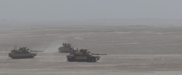 U.S. Army Soldiers with 1st Battalion, 6th Infantry Regiment, 2nd Brigade Combat Team, 1st Armored Division, drive armored vehicles toward a simulated breaching of a mine-wire obstacle during a situational training exercise part of Iron Union 14, Jan. 31, 2021, at Al Hamra Training Center in United Arab Emirates. Events like Iron Union enhance military-to-military partnerships by allowing Soldiers from the U.S. Army and UAE Land Forces to learn the tactics, techniques, and procedures of a key partner and to increase their readiness and interoperability. (U.S. Army photo by Staff Sgt. Daryl Bradford, Task Force Spartan Public Affairs.)