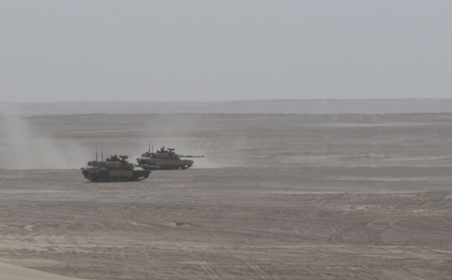 U.S. Army M-1 Abrams tanks assigned to 1st Battalion, 6th Infantry Regiment, 2nd Brigade Combat Team, 1st Armored Division, provide security after simulating a breach of a mine-wire obstacle during a situational training exercise part of Iron Union 14, Jan. 31, 2021, at Al Hamra Training Center in United Arab Emirates. Events like Iron Union enhance military-to-military partnerships by allowing Soldiers from the U.S. Army and UAE Land Forces to learn the tactics, techniques, and procedures of a key partner and to increase their readiness and interoperability. (U.S. Army photo by Staff Sgt. Daryl Bradford, Task Force Spartan Public Affairs.)