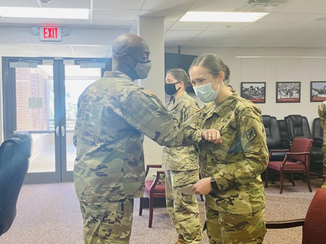 Brig. Gen. Milford H. ‘Beags’ Beagle Jr., Fort Jackson commander, presents coins from Gen. Paul Funk II, commander of Training and Doctrine Command, to Soldiers and civilians who helped make the virtual event a success. (Courtesy photo)