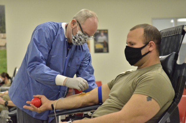 Sergeant First Class Daniel Barsi, 1st Battalion, 187th Infantry Regiment, 3rd Brigade Combat Team, 101st Airborne Division (Air Assault), squeezes a stress ball as Ty Allen, phlebotomist with the Armed Services Blood Program, prepares to draw blood. Feb. 5, during a drive at the Soldier Support Center.
