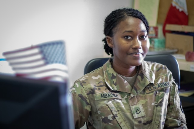 Pfc. Sokhna Khadija Mbacke, a human resources specialist in the 2nd Brigade Combat Team, 34th Infantry Division, Iowa Army National Guard, poses for a portrait in her office at Camp Maréchal de Lattre de Tassigny, Kosovo, on Feb. 3, 2012. Mbacke is currently deployed to Kosovo in support of Regional Command-East, Kosovo Force. (U.S. Army National Guard photo by Sgt. Zachary M. Zippe)