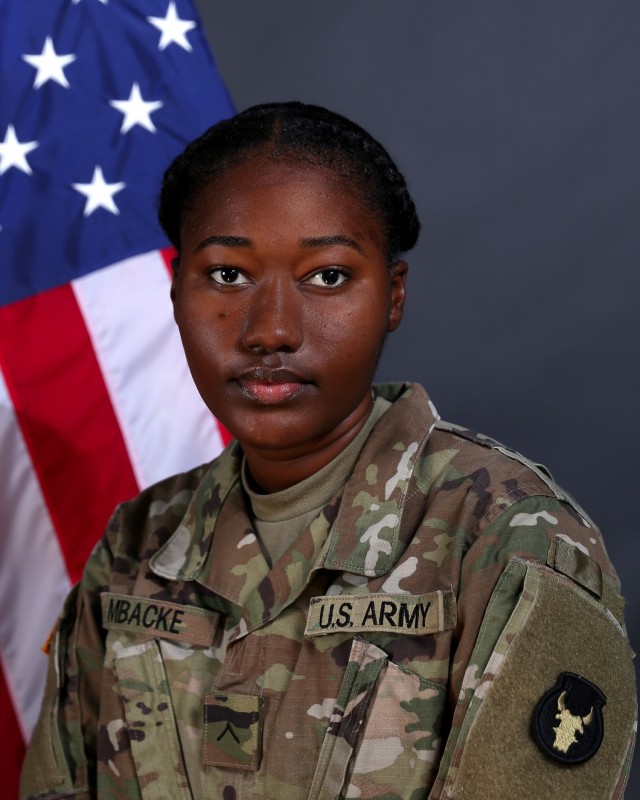 Now Pfc. Sokhna Khadija Mbacke, a human resources specialist in the 2nd Brigade Combat Team, 34th Infantry Division, Iowa Army National Guard, poses for a patching ceremony photo at Camp Dodge Joint Maneuver Training Center in Johnston, Iowa, on Oct. 14, 2020. The IANG patching ceremony welcomes new Soldiers who have just completed their initial training. Mbacke is currently deployed to Kosovo in support of Regional Command-East, Kosovo Force. (U.S. Army National Guard photo by Sgt. Zachary M. Zippe)