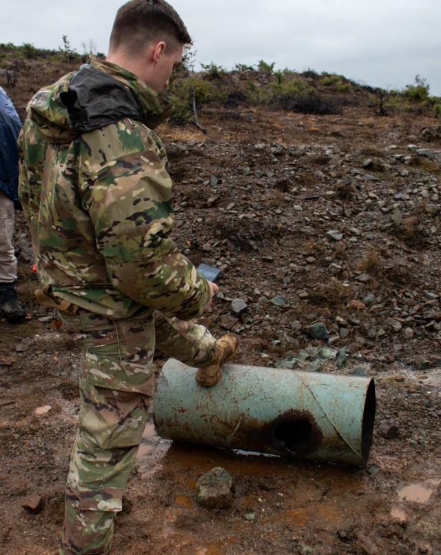 1st Lt. Taylor Firn, platoon leader of the 702nd Ordnance Company, attached to Regional Command-East, Kosovo Force, inspects the results of an explosive detonator demonstration during a Mine Action Training Kosovo range day outside Dakovica/Gjakovë, Kosovo, on Feb. 11, 2021. MAT Kosovo practiced low-ordering techniques. A process by which the original high-explosive is burned away and rendered useless.