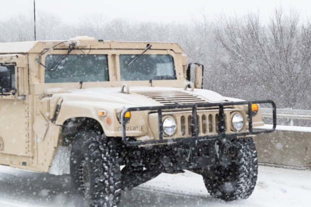 An Oklahoma Army National Guard HUMVEE moves through the snow near Stroud, Oklahoma.  The Oklahoma Army National Guard in partnership with the Oklahoma Highway Patrol responded to numerous calls for help caused by severe weather conditions as part...