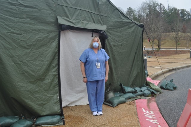 Martin Army Community Hospital Medical Support Assistant Tara Hopkins works in BMACH's pandemic tent, documenting COVID screening and testing results.