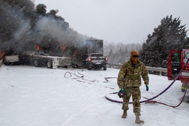 Spc. Parker Sargent,  2120th Engineer company, assists motorists on the Turner Turnpike following a wreck near Chandler, Oklahoma. ...