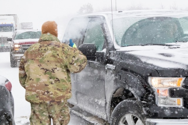 Spc. Parker Sargent, a member of the  2120th Engineer company, assists motorists on the Turner Turnpike following a wreck near Chandler, Oklahoma.  The Oklahoma Army National Guard in partnership with the Oklahoma Highway Patrol responded to...