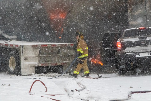 A fireman works to put out a burning vehicle on the Turner Turnpike following a wreck near Chandler, Oklahoma.  The Oklahoma Army National Guard in partnership with the Oklahoma Highway Patrol responded to numerous calls for help caused by severe...