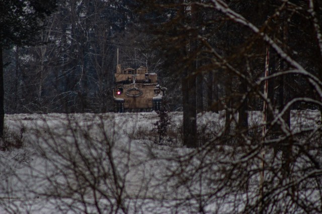 A Bradley from 1st Squadron 7th Cavalry Regiment reconnoiters an objective in support of a Fire Coordination Support Exercise at Grafenwoehr Training Area, Germany Feb. 9.