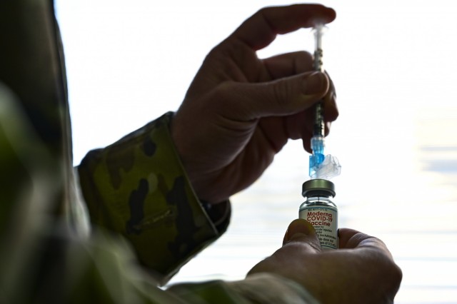 Tech. Sgt. Joseph Anthony, 911th Aeromedical Staging Squadron aeromedical technician, prepares to fill a syringe with the COVID-19 vaccine at the Pittsburgh International Airport Air Reserve Station, Pennsylvania, Feb. 4, 2021. The U.S. Air Force...