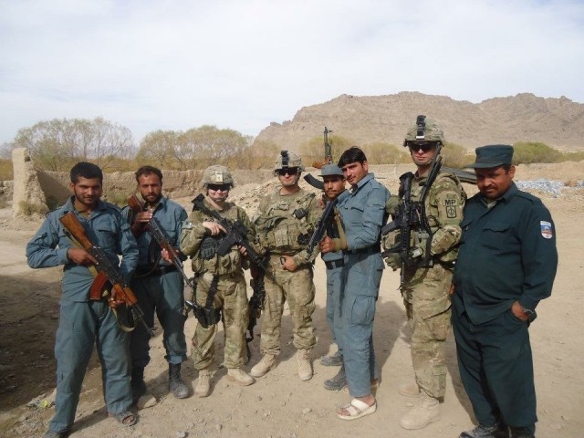 Sgt. 1st Class Michael Raines (second from right), a military police Soldier with the 29th Military Police Company, Maryland Army National Guard, poses for a photo with members of the Afghanistan National Police while deployed in support of Operation Enduring Freedom in 2012. Raines, then assigned to the 58th MP Company based out of Schofield Barracks, Hawaii, was promoted to sergeant during that deployment and is lifelong friends with the Soldiers he led in his platoon. (Courtesy photo)