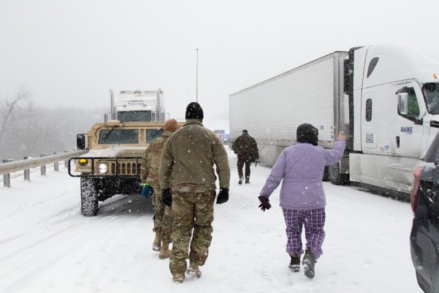 Sgt. 1st Class Josh Jacox and Spc. Parker Sargent, both members of the 2120th Engineer Company, assist motorists on the Turner Turnpike following a wreck near Chandler, Oklahoma. ...