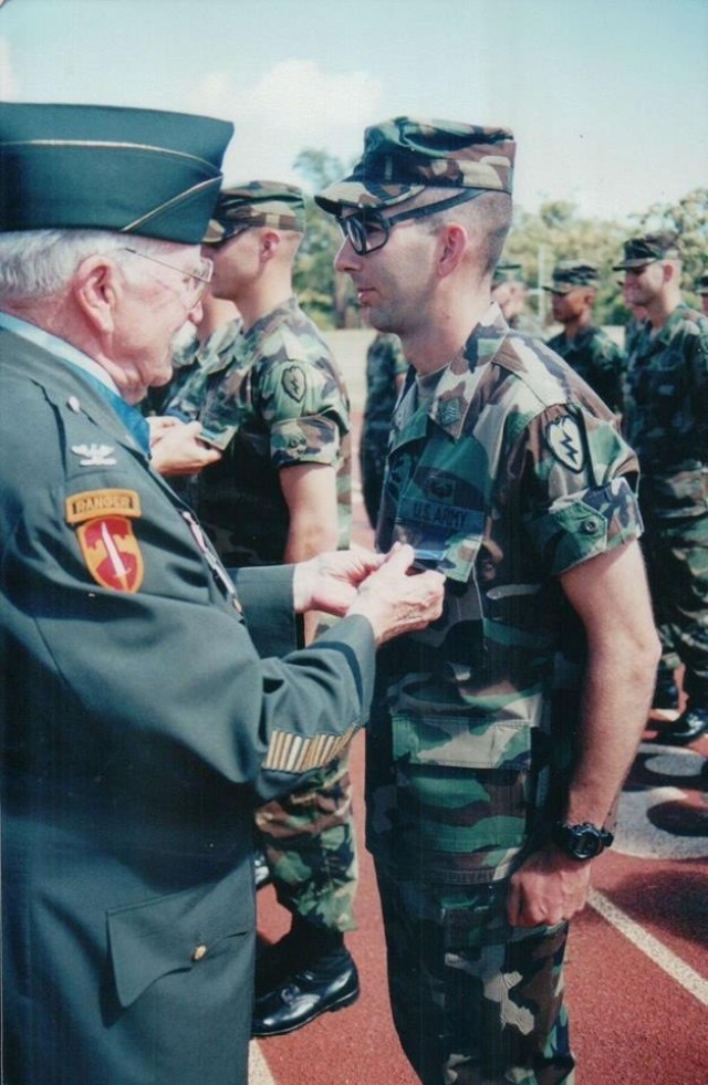 FORT BENNING, Ga. – Command Sgt. Maj. Robert K. &#34;Rob&#34; Fortenberry, when he was a sergeant, receives his Expert Infantryman Badge at Schofield Barracks, Hawaii, in late 1998 or early 1999. Fortenberry, a veteran Infantryman who has served as a drill sergeant, led troops in combat, and graduated from the U.S. Army&#39;s grueling Ranger School at age 45, is retiring after more than 30 years in uniform. Since 2019 he has served as senior enlisted leader at the U.S. Army Infantry School at Fort Benning, and relinquishes his responsibilities with the school in a ceremony here Feb. 22. Pinning on Fortenberry&#39;s EIB is retired Army Col. Lewis L. Millett, who during the Korean War received the Medal of Honor for leading a bayonet charge that drove Chinese troops from their positions on a hill in South Korea.

(Photo courtesy of Command Sgt. Maj. Robert K. Fortenberry)

