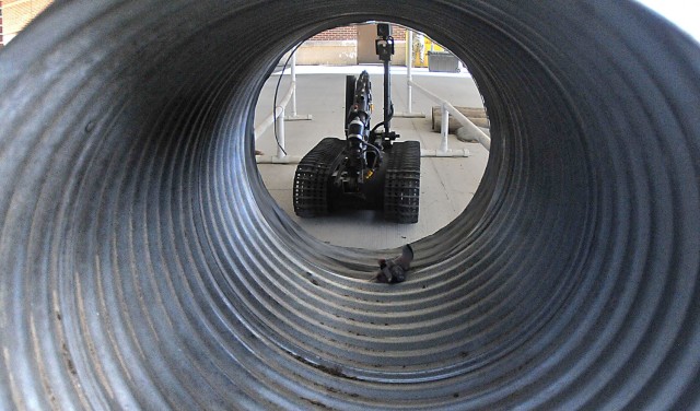 A remote controlled-explosive ordnance disposal robot approaches a tunnel to retrieve a stuffed toy during EOD Specialist Course familiarization Feb. 4 at Rose Hall located on the Ordnance Campus.