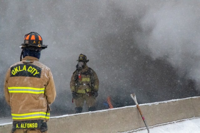 Firemen work to extinguish a multi-vehicle fire on the Turner Turnpike following a wreck near Chandler, Oklahoma. ...