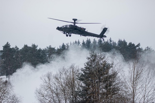 an AH-64 Apache from 1st Battalion, 101st Combat Aviation Brigade hovers as it waits to fire its weapons in support of a Fire Coordination Support Exercise at Grafenwoehr Training Area, Germany Feb. 9.
