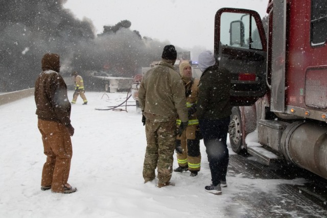 Staff Sgt. Josh Jacox, 2120th Engineer company, assists motorists to assist motorists on the Turner Turnpike following a wreck near Chandler, Oklahoma.  The Oklahoma Army National Guard in partnership with the Oklahoma Highway Patrol responded to...