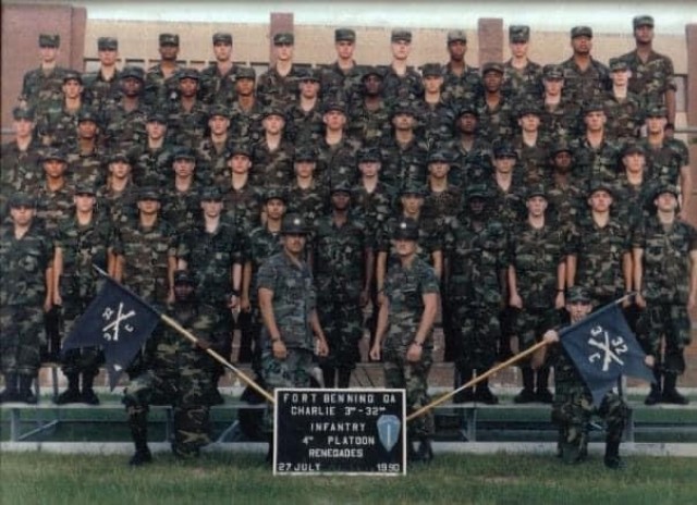 FORT BENNING, Ga. – Command Sgt. Maj. Robert K. "Rob" Fortenberry (kneeling, front, at right, holding guidon) when he was a private about to graduate from Infantry One-Station Unit Training at Fort Benning in July 1990, poses with...